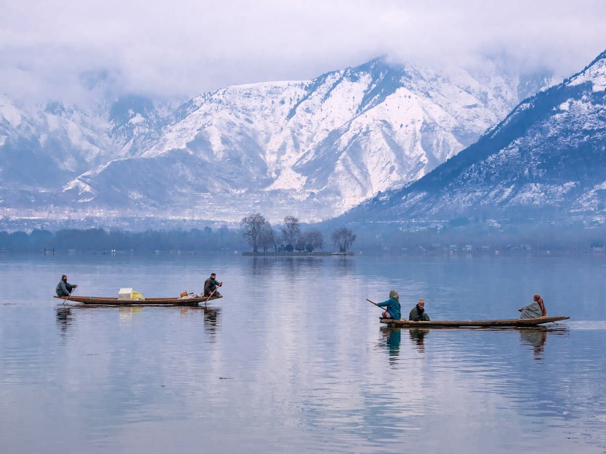 Kashmir shikara boat with snowy Himalayan peaks